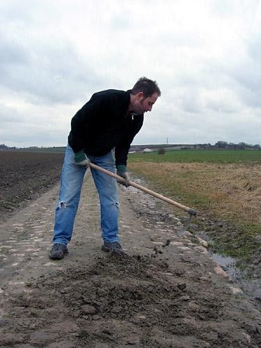 Ben Atkins slaves away clearing the mud from some cobbles