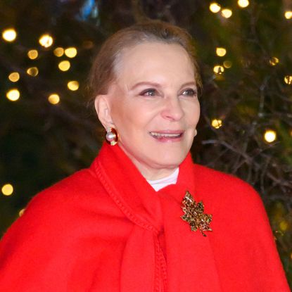 Princess Michael of Kent wears an oversized bright red shawl with a brooch for Princess kate's carol concert