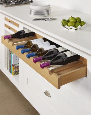 Wine drawer in kitchen cabinet with white finish
