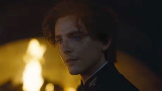 Timothee Chalamet in front of a fire in Dune Part 3