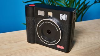 A black Kodak Mini Shot 4 Era 2-in-1 instant camera and printer