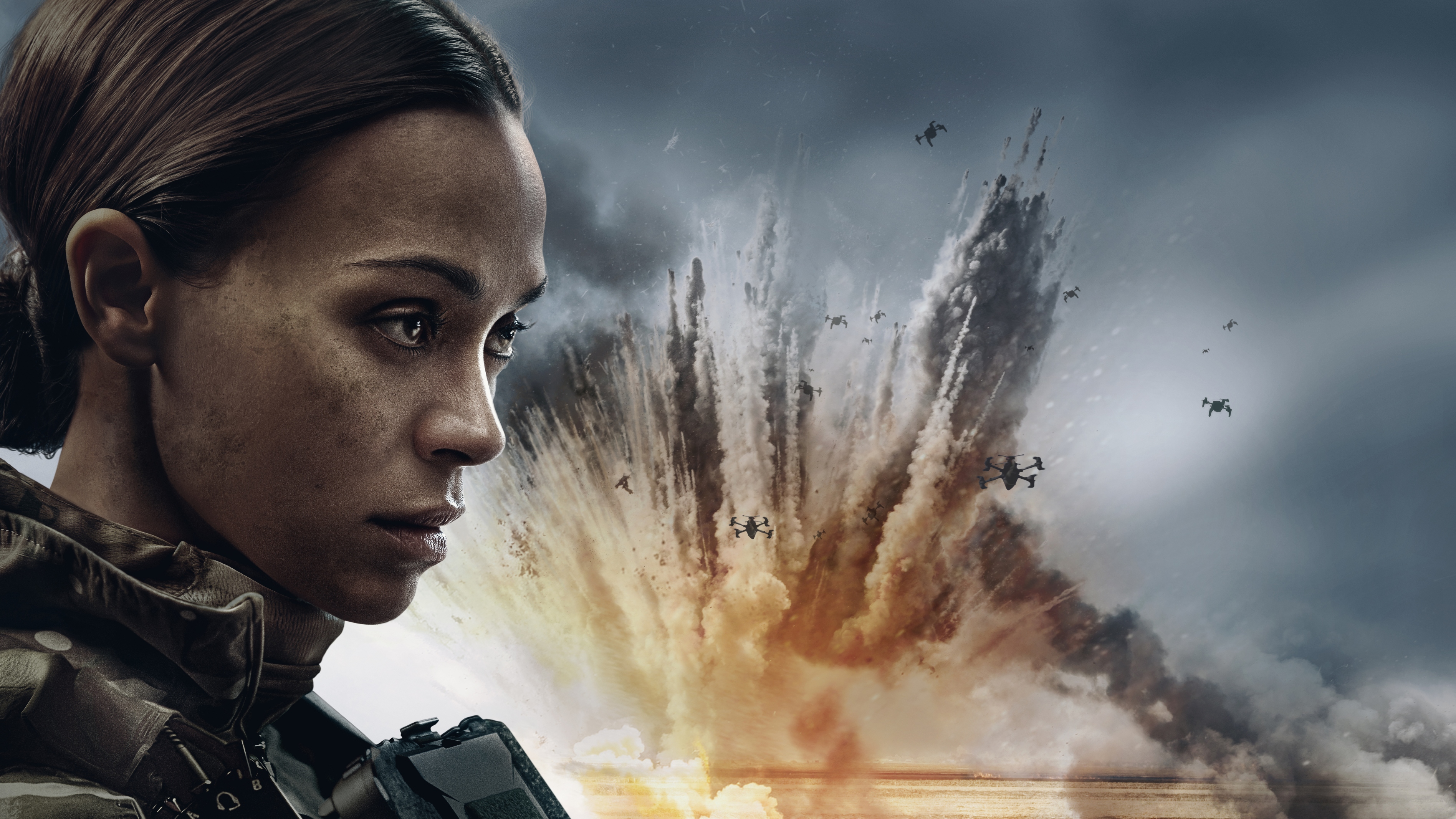 Lioness season 3 key art. Zoe Salda&ntilde;a as Joe looking off to the distance with an explosion and drones behind her.
