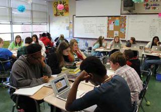 ACSF middle-school students using their MacBooks in the classroom.  