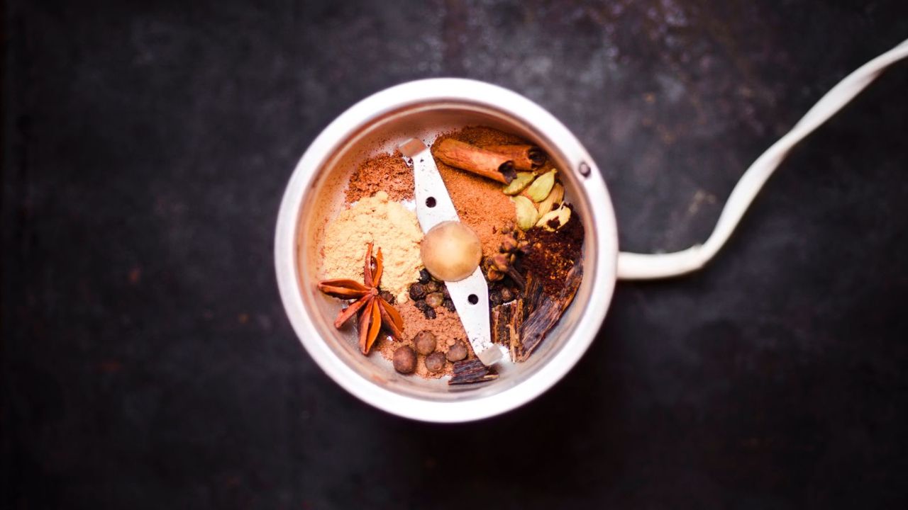 A coffee grinder filled with spices, proving you can use a coffee grinder to grind spices