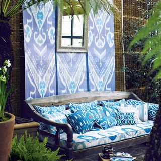 garden area with hanging wallpaper with blue sofa