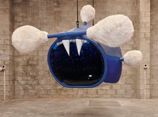 Large sea creature by Porky Hefer with blue body and white oversized earbuds