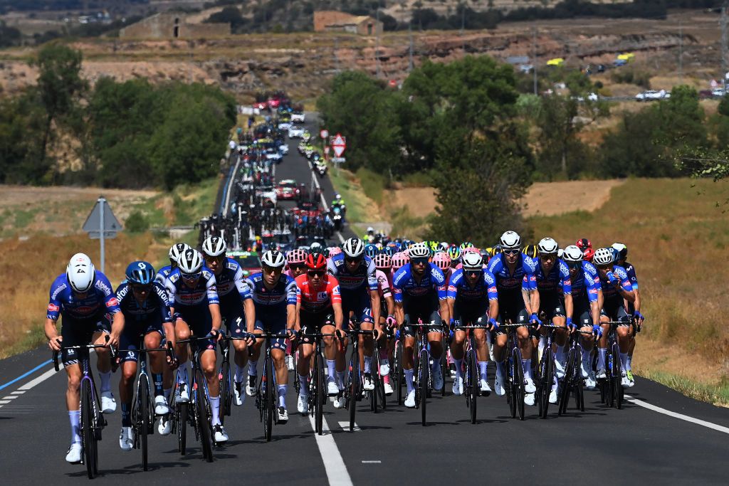 TARRAGONA SPAIN AUGUST 29 A general view of Remco Evenepoel of Belgium Louis Vervaeke of Belgium Mattia Cattaneo of Italy Andrea Bagioli of Italy Jan Hirt of Czech Republic James Knox of The United Kingdom Casper Pedersen of Denmark Pieter Serry of Belgium and Team Soudal Quick Step and Romain Bardet of France Romain Combaud of France Lorenzo Milesi of Italy Alberto Dainese of Italy Sean Flynn of The United Kingdom Chris Hamilton of Australia Max Poole of The United Kingdom and Team DSM firmenich lead the peloton during the 78th Tour of Spain 2023 Stage 4 a 1846km stage from Andorra la Vella to Tarragona UCIWT on August 29 2023 in Tarragona Spain Photo by Tim de WaeleGetty Images