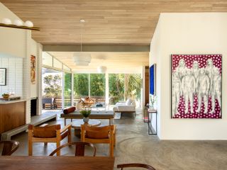open plan dining and living room in neutral palette and with art on walls