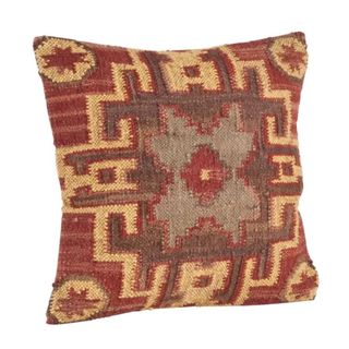 A rustic throw pillow with a red, yellow, and brown square pattern design