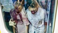 Performers acting as zombies are seen on a train coach during the "Train to Apocalypse" event as part of the Pandora Box Artmire Festival 2024 held to attract commuters to ride the city's rapid transit system LRT (light rapid transit), in Jakarta on July 11, 2024. (Photo by BAY ISMOYO / AFP) (Photo by BAY ISMOYO/AFP via Getty Images)