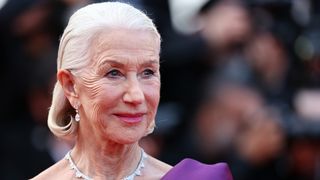 Helen Mirren wears a purple gown with a rosy pink lipstick and a curled slicked-back bob