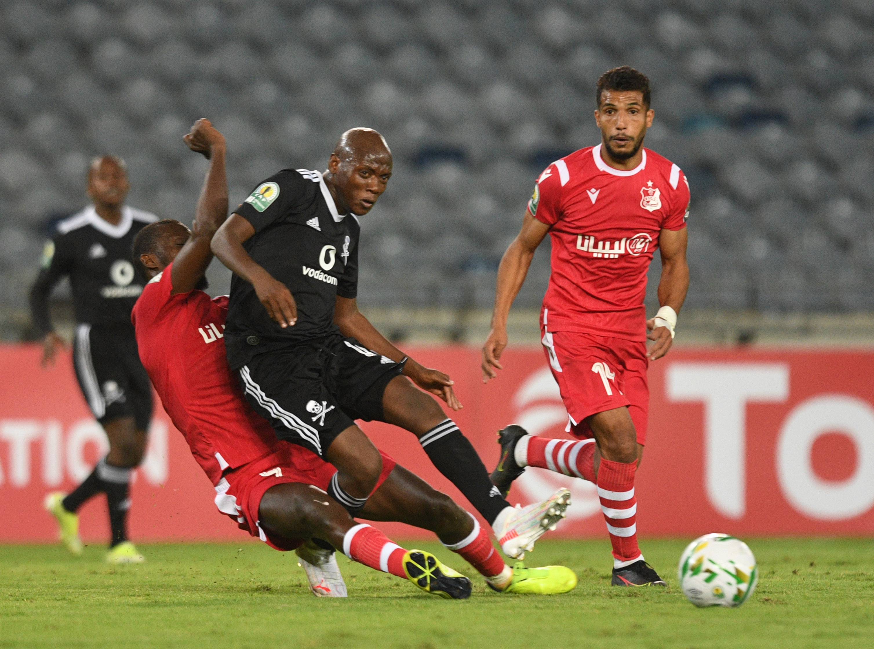 Kabelo Dlamini of Orlando Pirates challenged by Mohamed Mohamed of Al Ahli Benghazi