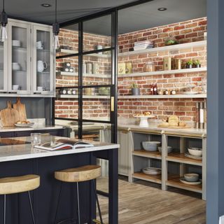 Red brick walled kitchen with open shelving storage units