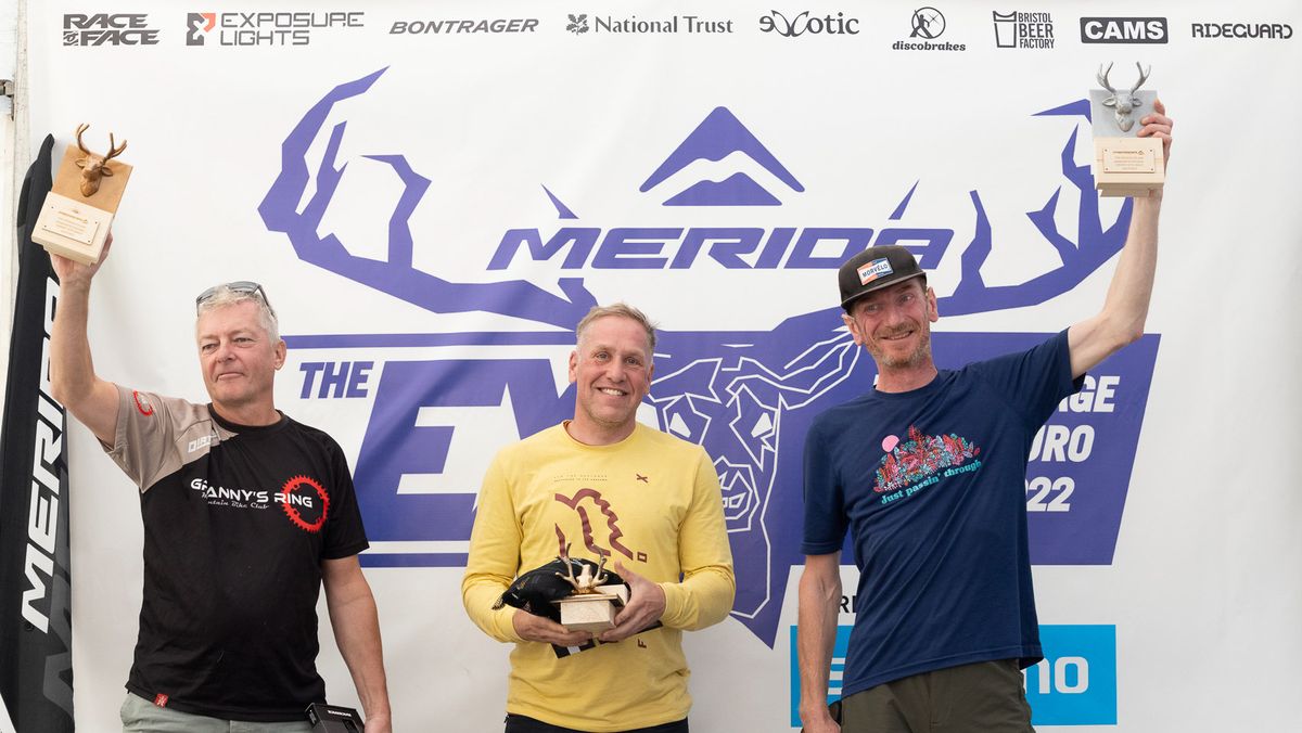 Men on a podium receiving prizes