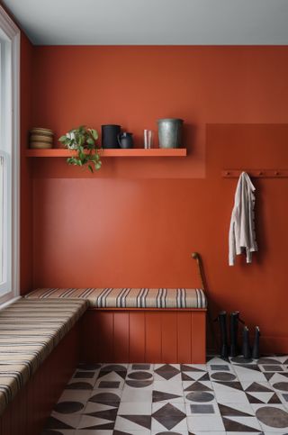 orange mudroom with striped cushions