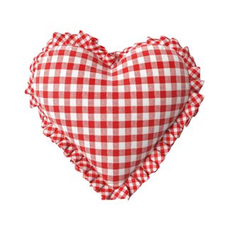 A red and white gingham heart shaped pillow with a fur trim