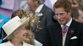 Britain's Queen Elizabeth II and Prince Harry share a joke as they watch Prince Charles and his bride Camilla Duchess of Cornwall leave St George's Chapel in Windsor following their marriage blessing, 09 April 2005. Prince Charles and his longtime sweetheart Camilla Parker Bowles married today after two months of muddled preparations and a lifetime of waiting. (Photo by ALASTAIR GRANT / POOL / AFP)