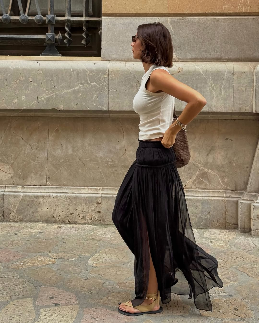 @smythsisters wears suede sandals with a white tank and black maxi skirt