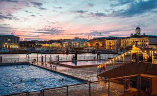 Water and buildings, people swimming