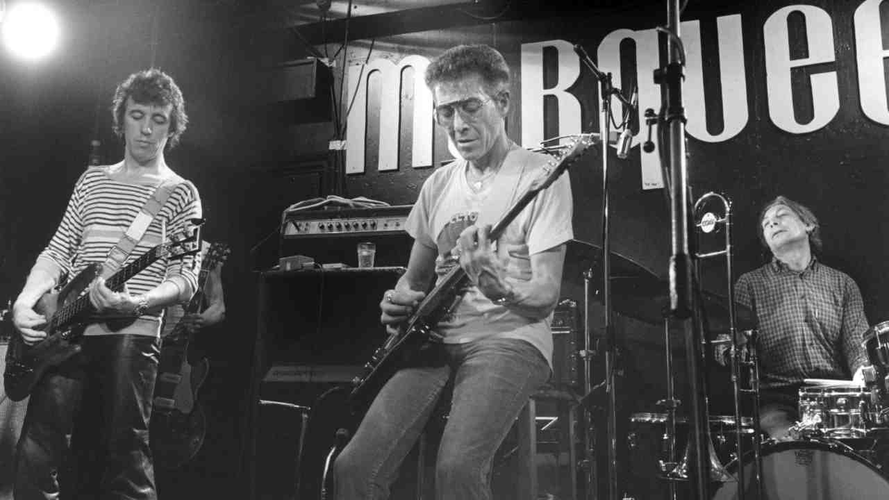 Alexis Korner performing live with Bill Wyman and Charlie Watts of the Rolling Stones in 1983