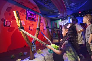Children Take Aim at Angry Birds Space Encounter Exhibit