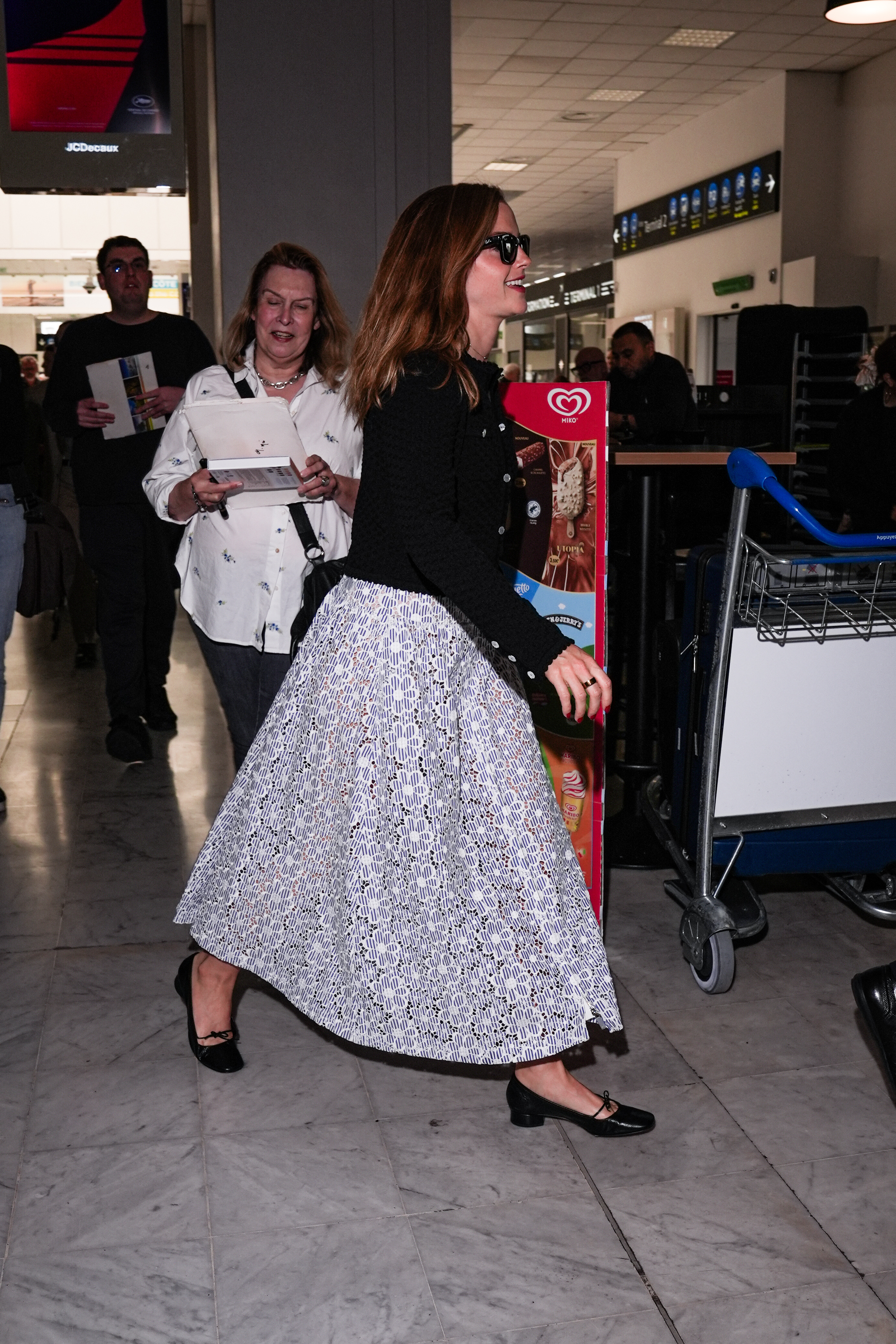 Emma Watson arrives at the Cannes airport wearing a Chanel dress