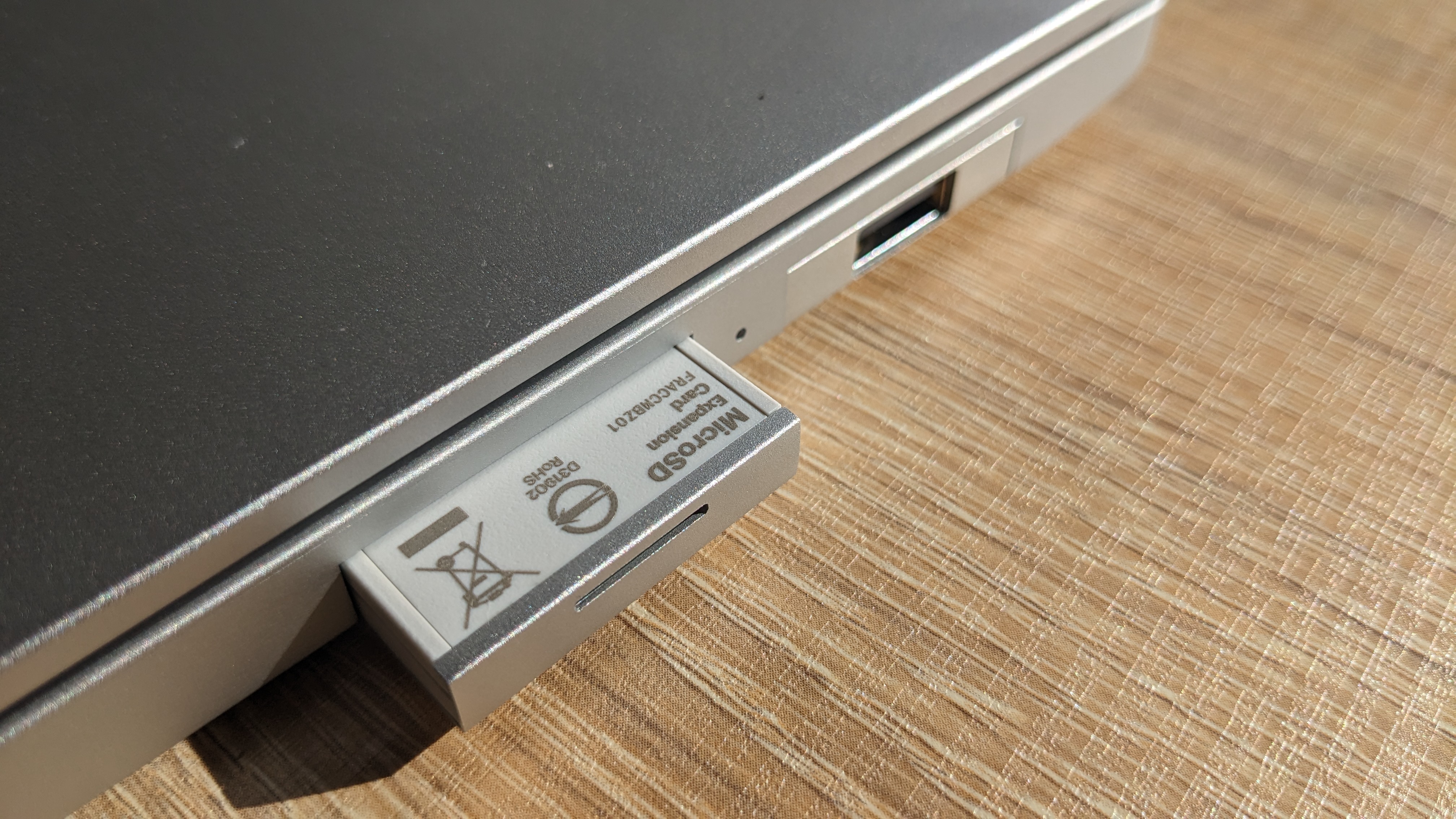 The Framework Laptop Chromebook Edition photographed on a wooden desk.