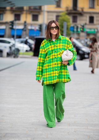 Lena Lademann seen wearing yellow green checkered flannel button shirt, green pants, Bottega Veneta pouch bag outside the Sportmax show during Milan Fashion Week Spring/Summer 2020 on September 20, 2019 in Milan, Italy.