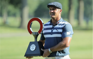 Bryson Dechambeau poses with the 2020 Rocket Mortgage Classic trophy