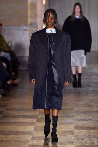 Raf Simons suggests men get back to the boardroom in a slouchy jacket and dress