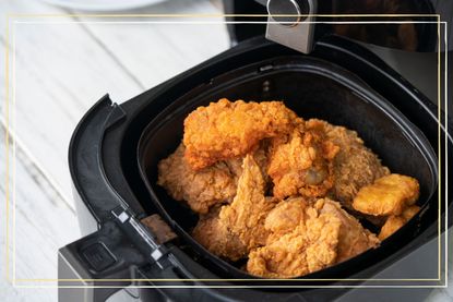 AN open air fryer drawer with fried chicken inside