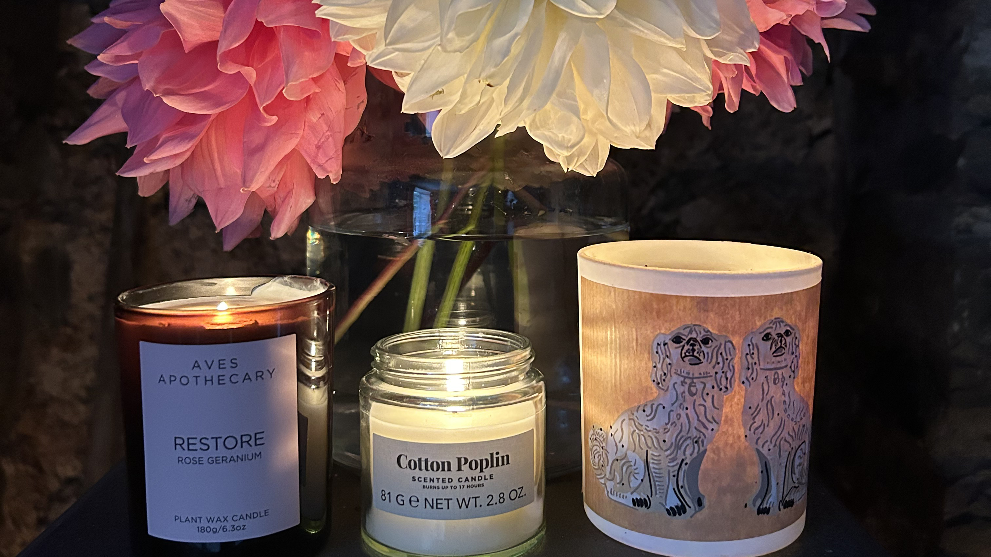 lit candles under a bunch of dahlias