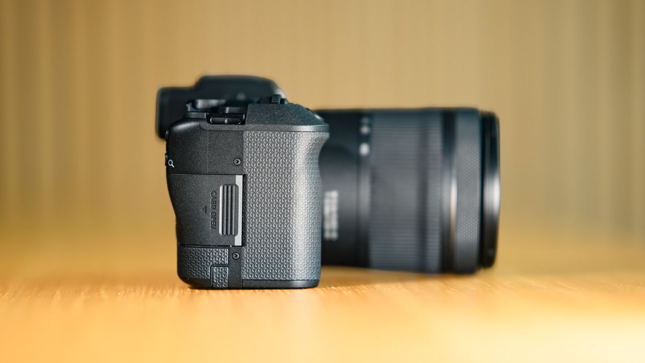 Side profile of the Canon EOS R8 Mark II, on a wooden table