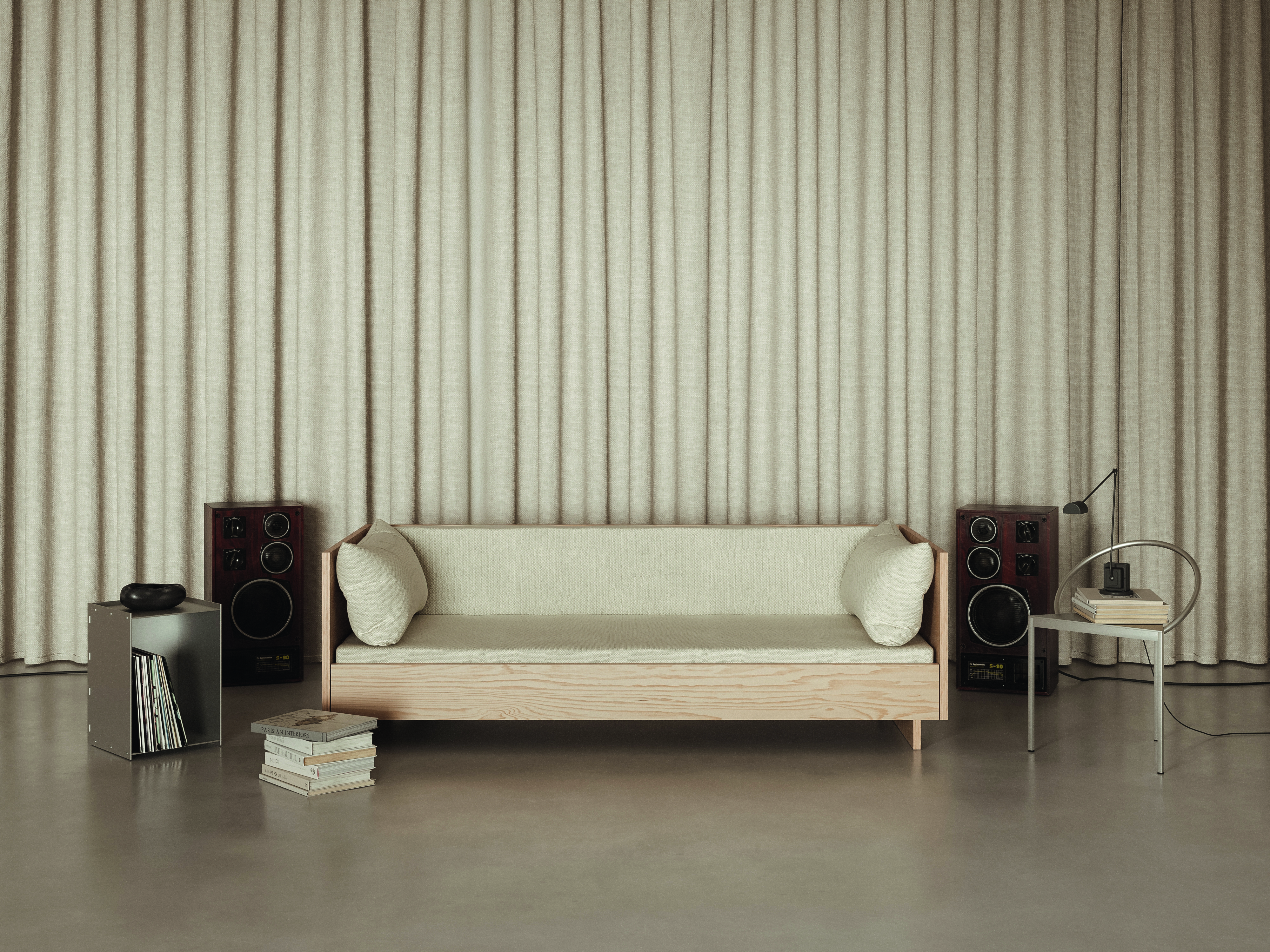 A minimalist, retro-inspired listening room features creamy curtains, a matching sofa with a wooden base, wooden speakers, and chrome details.