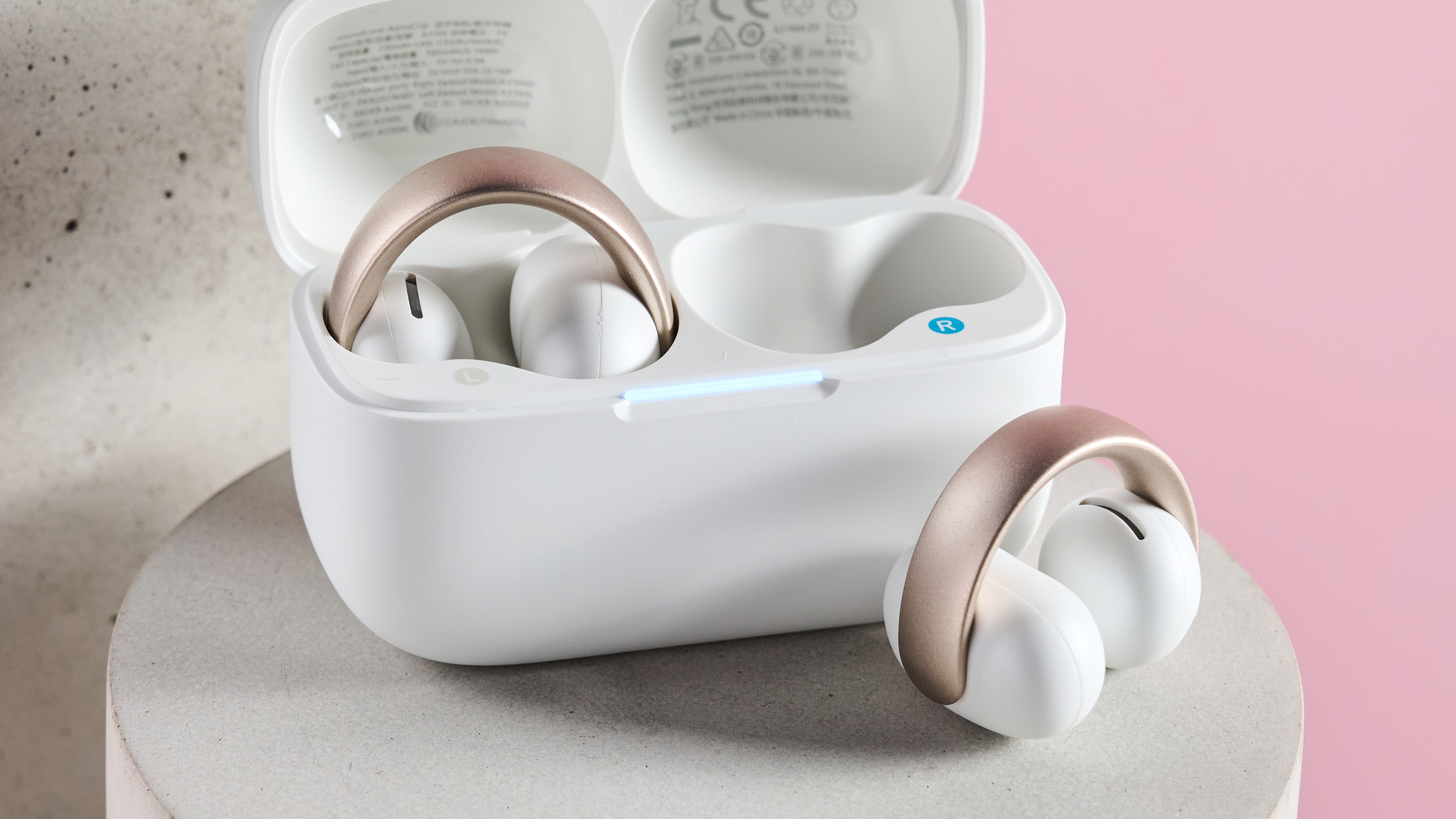 One bud inside the Anker Soundcore AeroClip charging and one positioned in front of the charging case