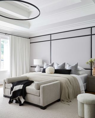 a bedroom with grey and black paneled walls