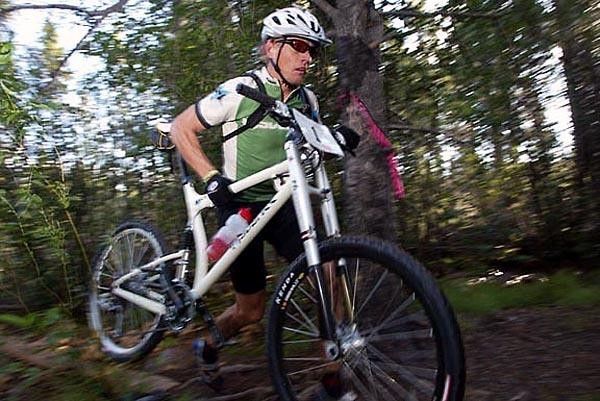 Dave Wiens runs with his bike