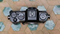 Fujifilm X-T50 camera top down view on a green a white table