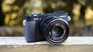 Sony RX1R III on a wooden surface in an outdoor environment