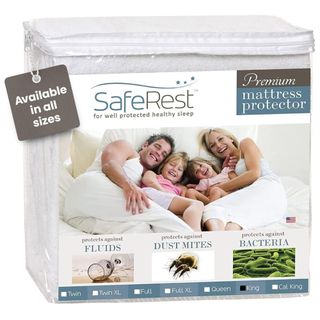 A white folded mattress protector in clear plastic packaging