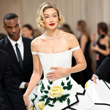 Gigi Hadid wearing an off the shoulder thom browne dress