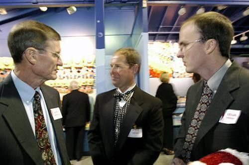 Steve Hegg (C) talks with Glen and Kenan Kirkendall in the Sea World arcade during the Competitor Magazine Endurance Sports Awards.