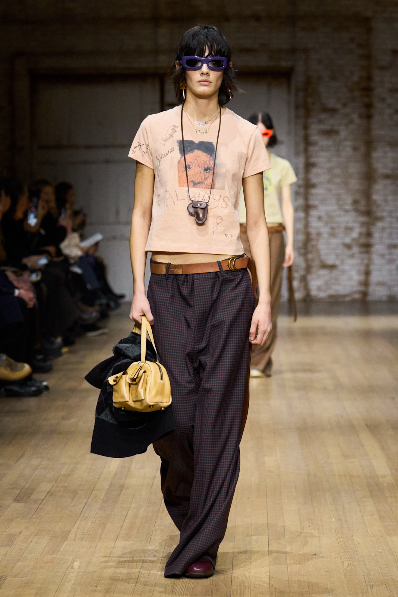 A model wore Lola Tung's plaid pants on the Coach Fall 2025 runway
