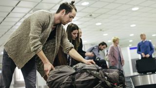 Travelers at baggage claim in an airport