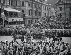 Cardboard periscopes are hoisted aloft in a bid to catch a brief glimpse of the Princesses Elizabeth and Margaret on the way to their father’s coronation on May 12, 1937. Credit: Getty