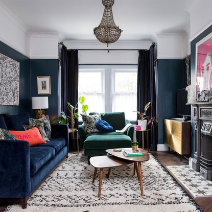 blue living room with blue velvet sofa and fireplace