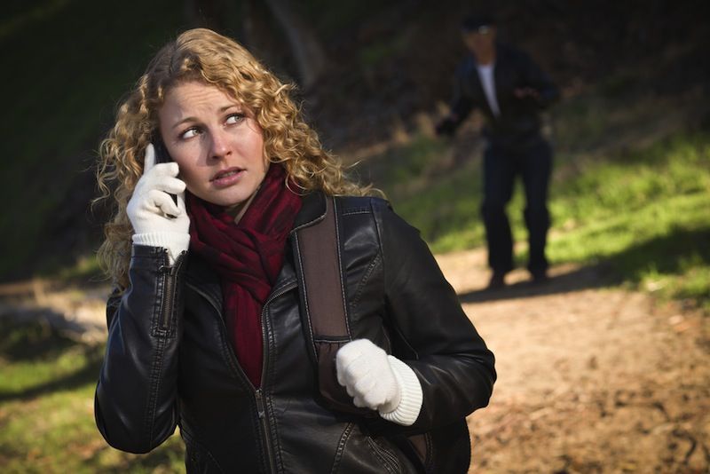 stalker on the left side of a woman