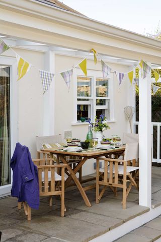 bunting above seating area outdoors on paving