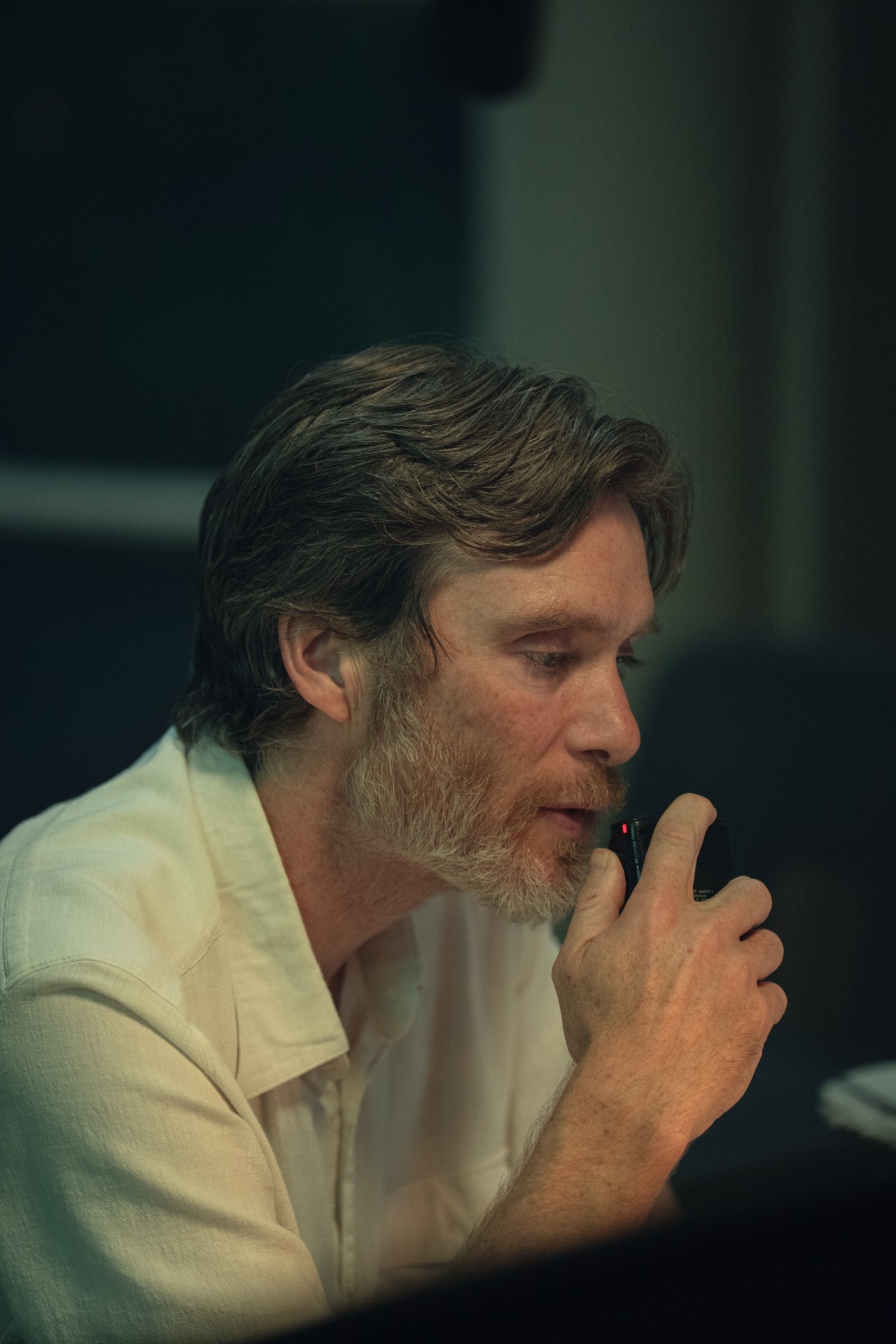 Cillian Murphy talking into his recorder in Steve.
