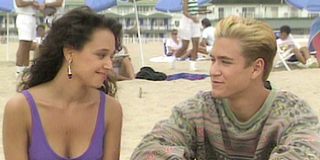 Saved by the Bell Leah Remini as Stacey Carosi looks at Zack Morris on the beach.